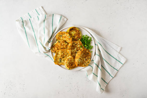 istock Zucchini pancake with onion and parsley on white background 1268540693