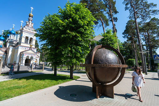 Jurmala, Latvia - June 21, 2020: The Church Of Our Lady Of Kazan and environmental object - metal sculpture \