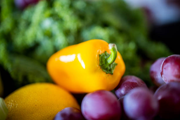 Fresh fruits and vegetables on a wooden table top.
