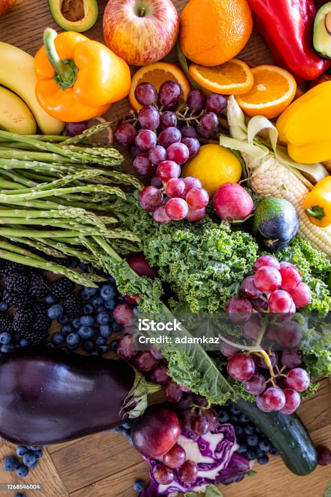 Fresh Fruits and Vegetables on Table Fresh fruits and vegetables on a wooden table top. Farm-To-Table Stock Photo