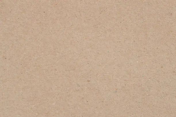 Photo of Texture of old organic cardboard, beige paper, background for design, copy space. Recyclable material, has inclusions of cellulose