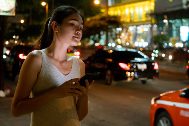 istock Asian women Use the Uber application service to request a ride on the go. 1268551917