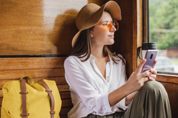 istock Beautiful woman using phone in train 1268552248
