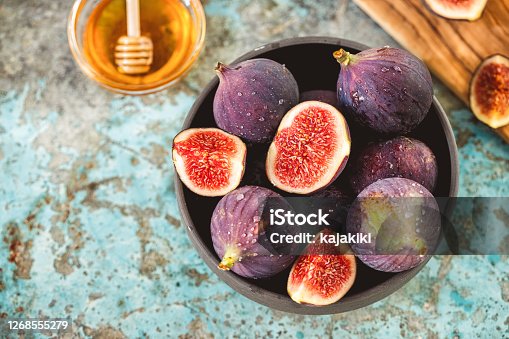 istock Fresh figs and honey on rustic background 1268555279