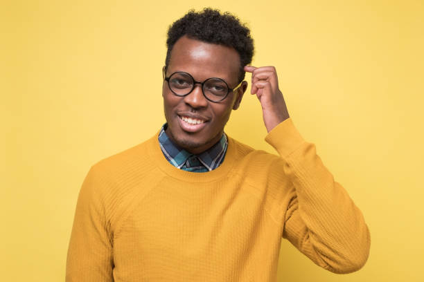 istock Handsome young african man wearing glasses smiling. 1268555290