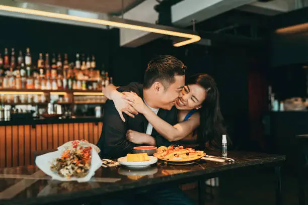 Photo of Beautiful asian couple celebrating Valentine's Day or birthday in a restaurant