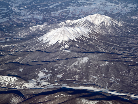 Aerial view of Pikes Peak in Colorado in winter with fresh snow covering the surrounding landscape