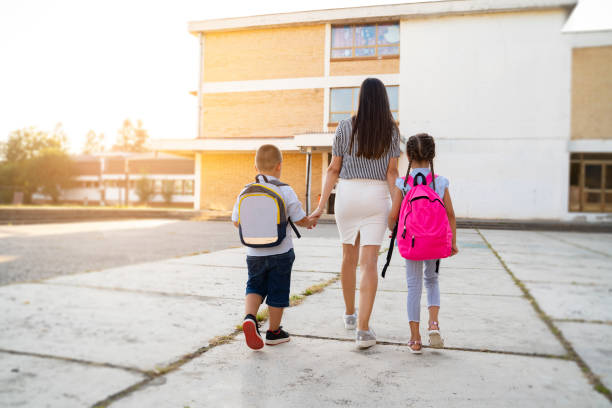 istock Young mother walking her kids to school 1268560103