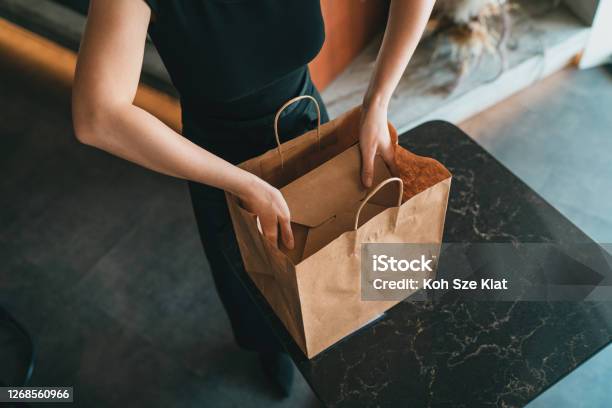 A Restaurant Employee Checking Online Orders For Delivery Stock Photo - Download Image Now