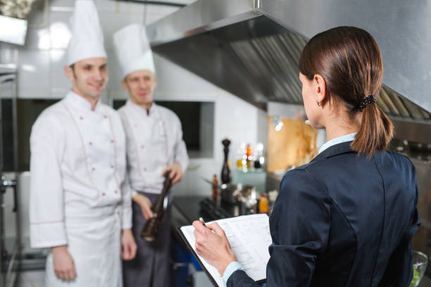 Restaurant manager briefing to his kitchen staff in the commercial kitchen.