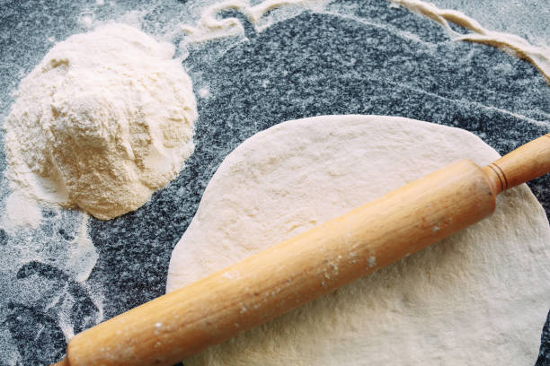 istock Knead the dough with the ingredients. The chef prepares pizza. 1268561617