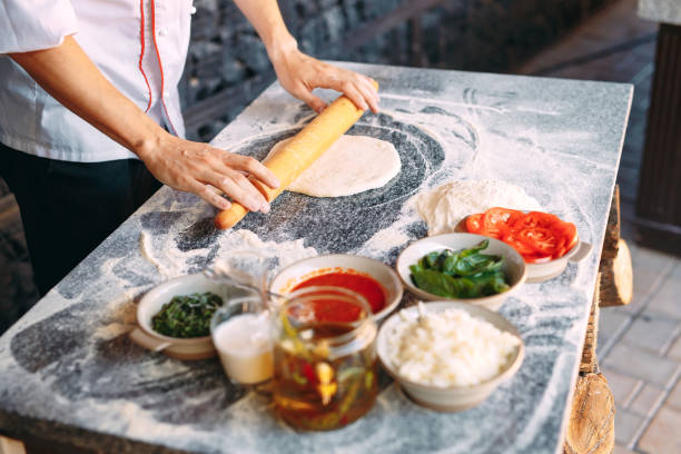 istock Cooking Pizza. Pizza ingredients on the table. 1268561801
