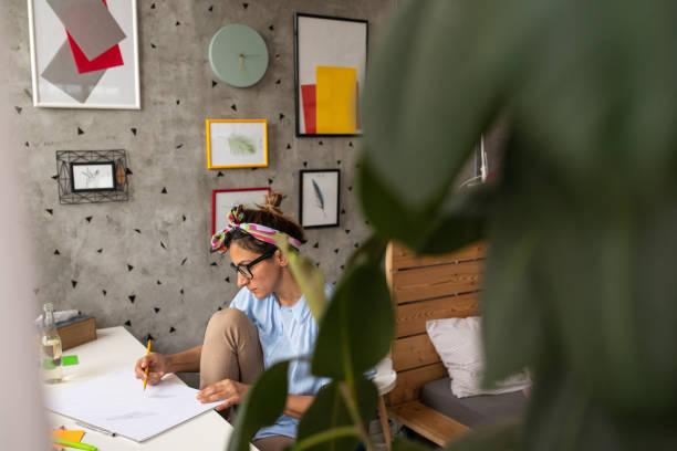 istock Woman concentrating while drawing at home 1268564095