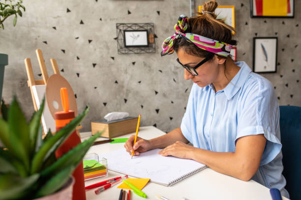 istock Woman concentrating while drawing at home 1268564131