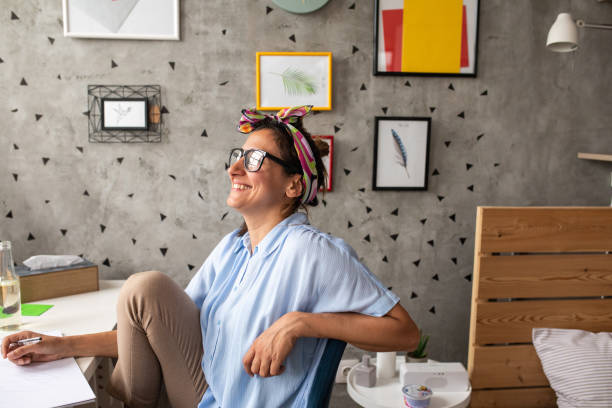 istock Happy female artist at home 1268564152
