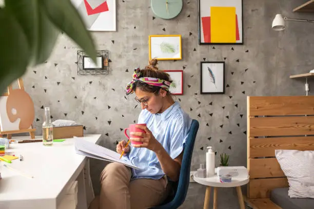 Photo of Female artist drawing at home