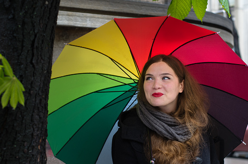 Girl with colorful umbrela on rainy day