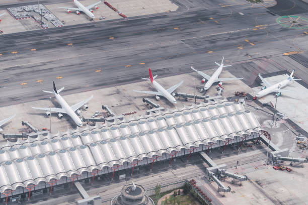 Aerial view of one of the terminals of Adolfo suarez airport in Madrid with several passengers planes attached to it. Travel. Famous place. Aerial view of one of the terminals of Adolfo suarez airport in Madrid with several passengers planes attached to it. Travel. Famous place. air transport building stock pictures, royalty-free photos & images