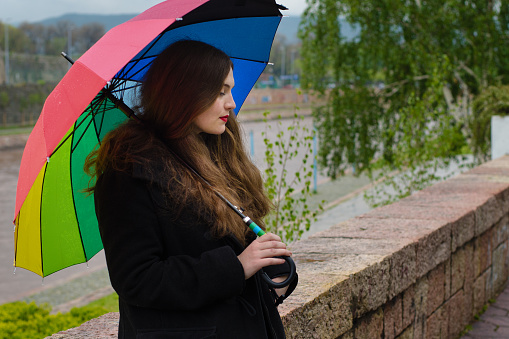 Girl with colorful umbrela on rainy day