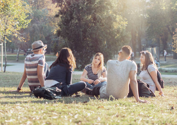 istock Young students talk and hang out outside 1268567137