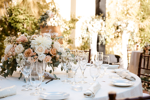 Outdoor reception table decor - round tables with white tablecloths and floral center pieces