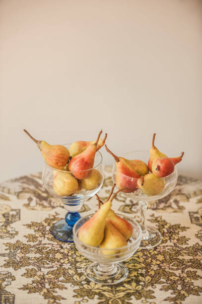istock June Beauty Pears in Glass Bowl on Table Decorated with Rustic Tablecloth 1268569887