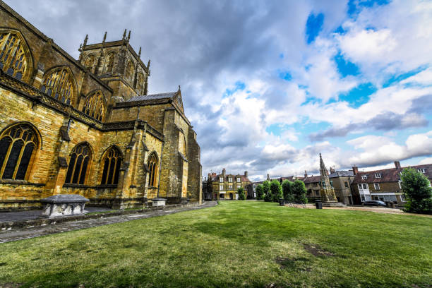 istock Sherborne Abbey And Green Grass Courtyard, UK 1268573434