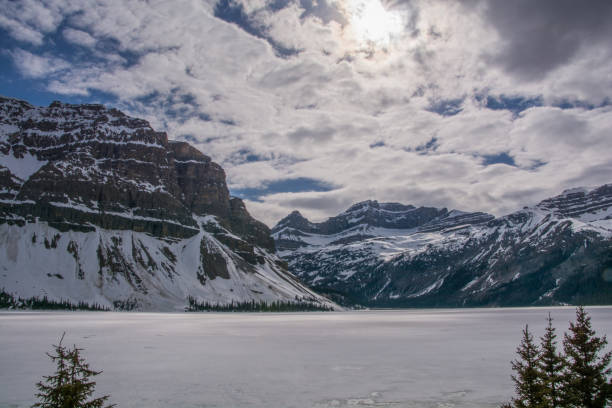 istock Frozen lake and snow capped mountains 1268573541