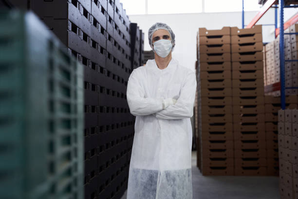 istock Young man in uniform standing in a warehouse 1268574695