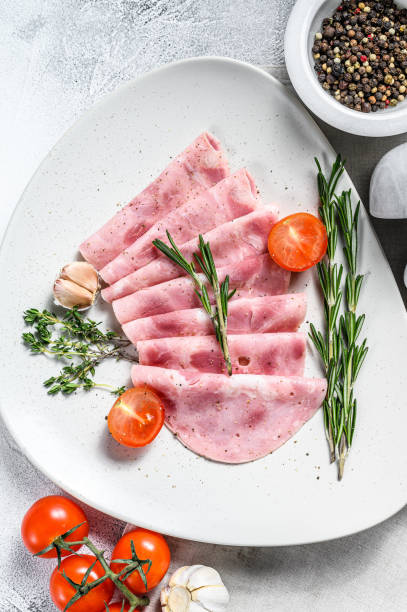 istock Sliced Pork ham. Fresh prosciutto.  White background. Top view 1268576718