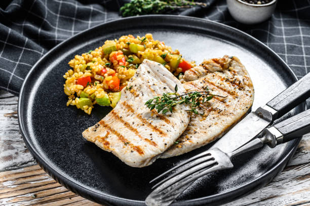 istock Grilled Turkey breast Steaks with quinoa salad. White background. Top view 1268576722