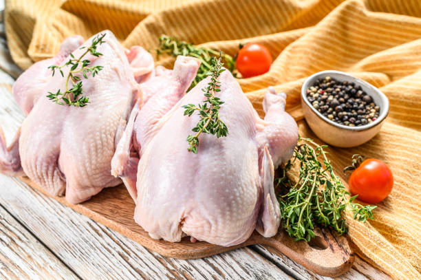 istock Whole raw Free range chicken with thyme and spices. White background. Top view 1268580240