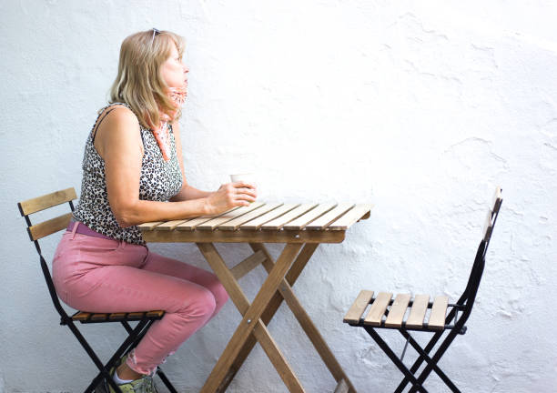 Woman at Cafe Table with Coffee during Pandemic