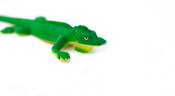 istock Plastic Green Toy Lizard on White Background 1268581387