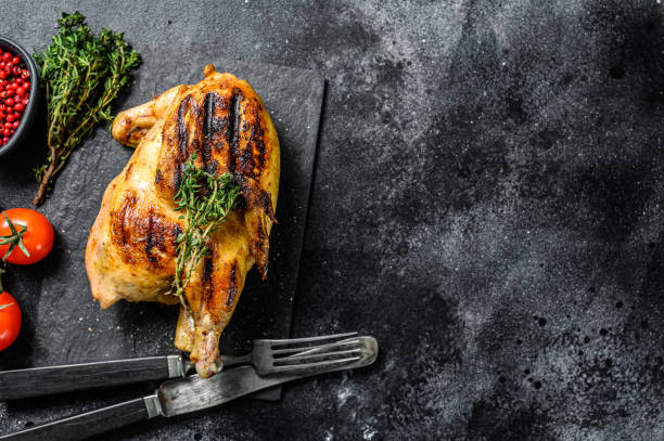 istock Baked whole farm chicken. Black background. Top view. Copy space 1268583138