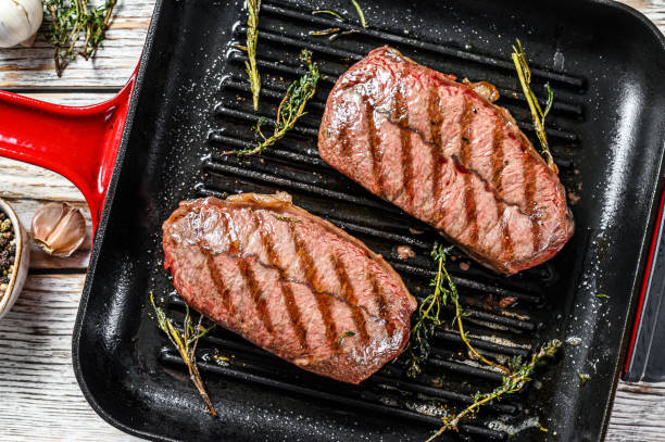 istock Ready to eat steak Top Blade beef breeds, black Angus meat. Gray background. Top view 1268583304