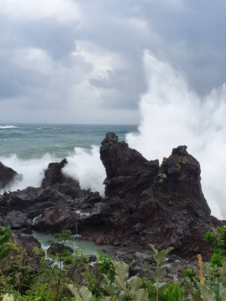 istock Sea Waves Breaking over Rocks with Splashes 1268583483
