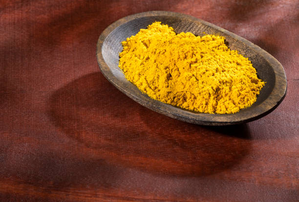 istock Organic curry powder in the wooden bowl - Text space 1268583654