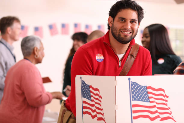 istock Mid-adult, Latin descent man votes in USA election. 1268583732