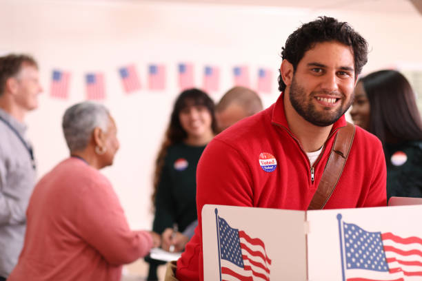 istock Mid-adult, Latin descent man votes in USA election. 1268583771