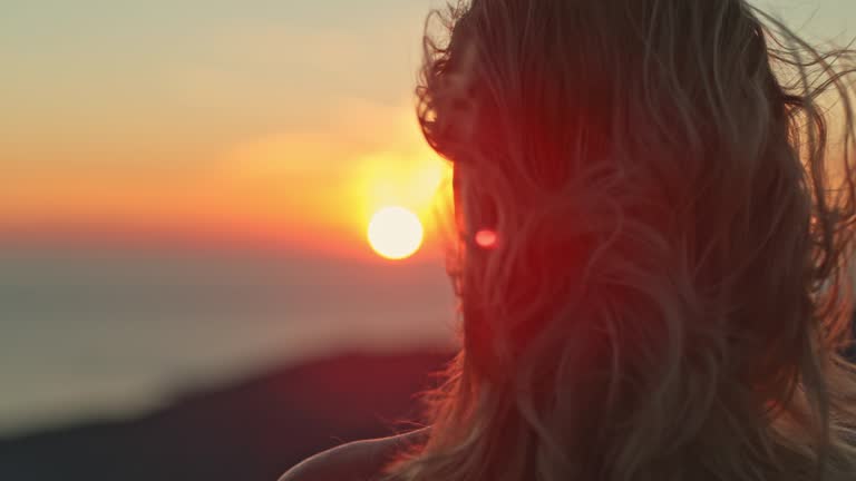 TIME WARP Woman enjoying the amazing seaview at sunset