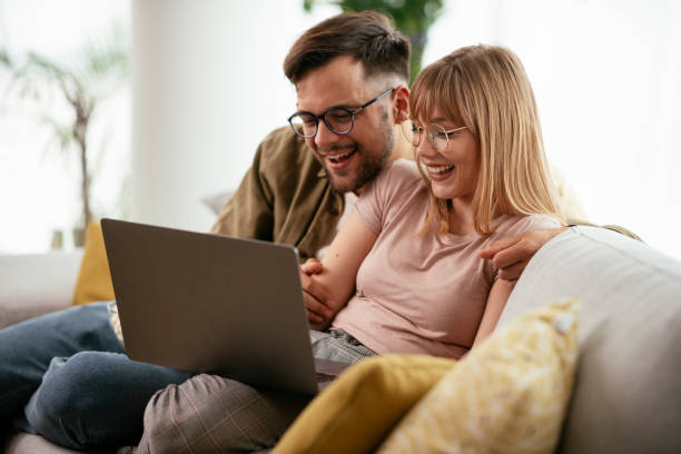 istock Young couple watching movie on lap top. 1268587392