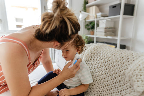 istock Body temperature check with an ear thermometer 1268588903