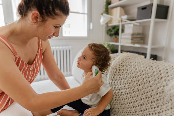 istock Body temperature check with an ear thermometer 1268588914