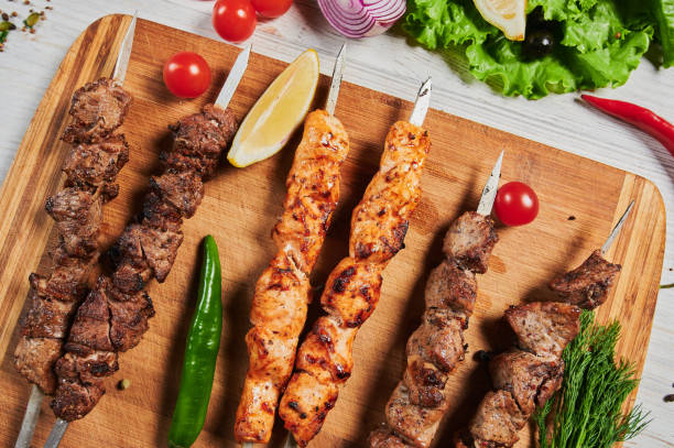 istock lamb shish kebab with vegetables on a wooden Board. 1268592993