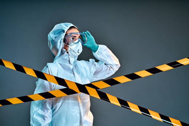 istock Quarantine zone. Researcher wearing hazmat protective suit and safety goggles. 1268593049