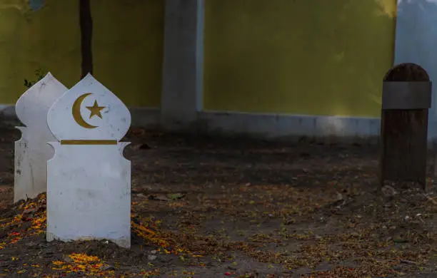 Islamic crescent moon with a star on white wooden. waxing moon muslim symbol on Islamic muslim graveyard in thailand.