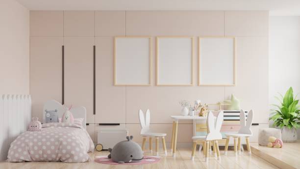 istock Mock up posters in child room interior, posters on empty cream color wall background. 1268593443