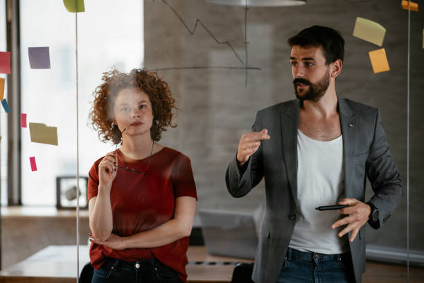 istock Businesswoman and businessman discussing work in office. 1268596384