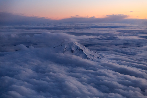 The summit of Mount Hood poking through a layer of clouds as a winter storm clears